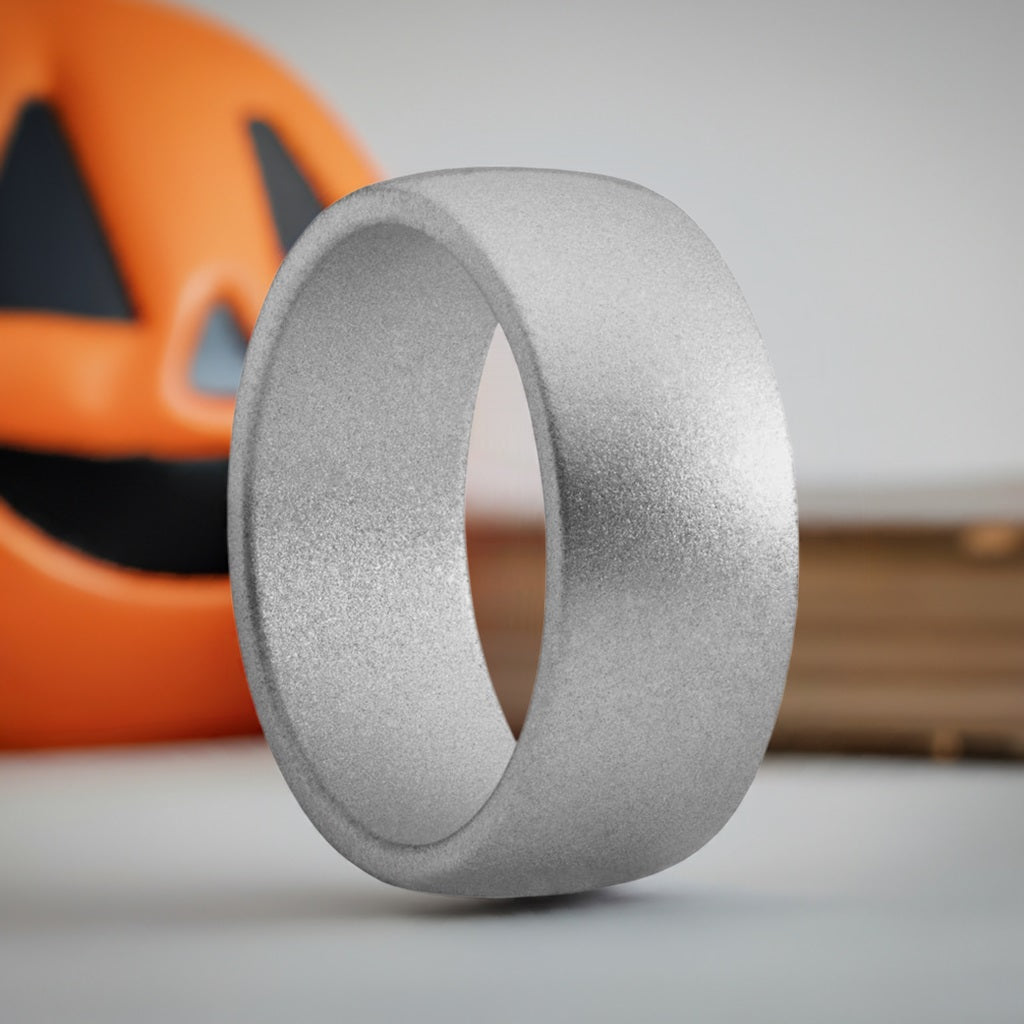 Silver Men's Silicone Rings Next To Orange Pumpkin